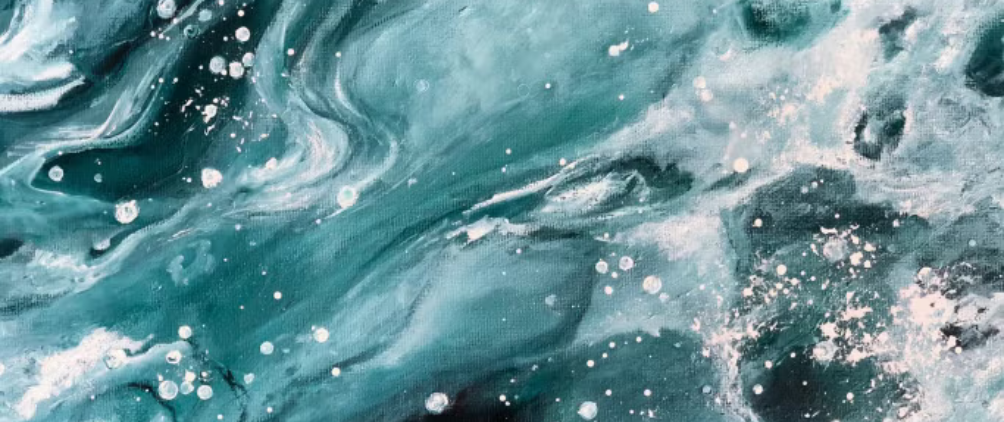 Close-up of a green palm leaf with sunlight creating a checkered pattern of light and shadow across its ridges.