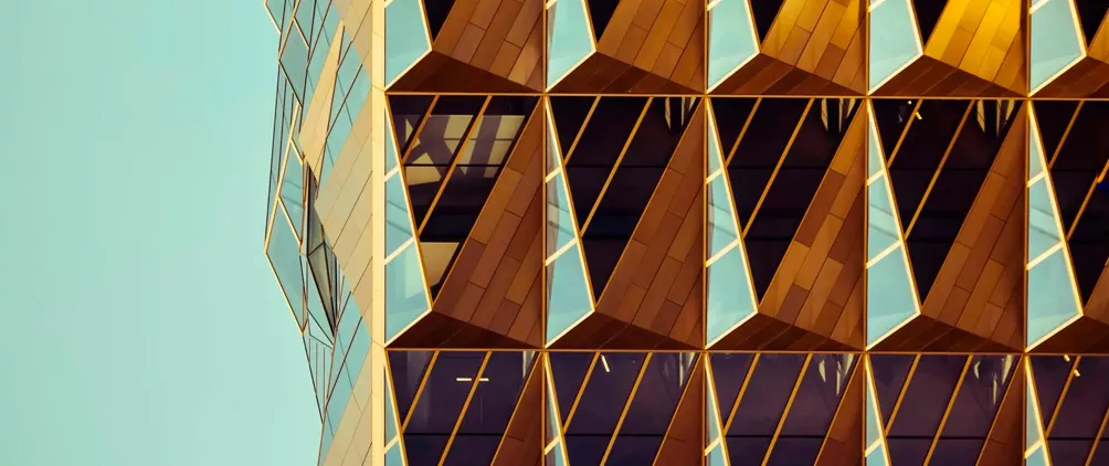 Geometric golden building facade representing structured finance, securitized markets and portfolio construction.