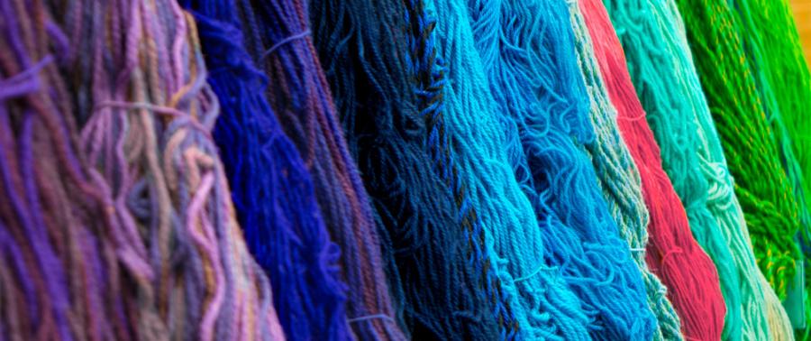 Colorful woven threads representing the diversification, flexibility and portfolio construction benefits of emerging market debt.